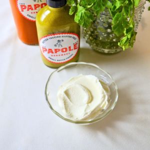 Papole Crema Sour Cream—smooth, rich Mexican-style crema in a glass bowl, with Papole sauces and fresh cilantro in the background.