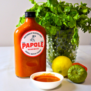 La Morita Red Sauce by Papole—smoky, spicy red sauce made with Morita chiles, displayed in a glass bottle with fresh ingredients.