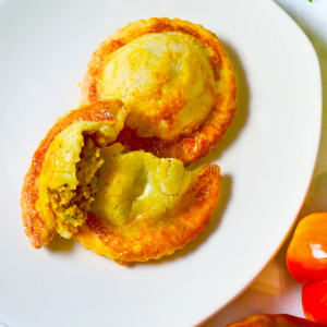 Gluten-free Moroccan Lentil Empanoli—flaky hand pies filled with slow-simmered lentils, tomatoes, and aromatic North African spices.